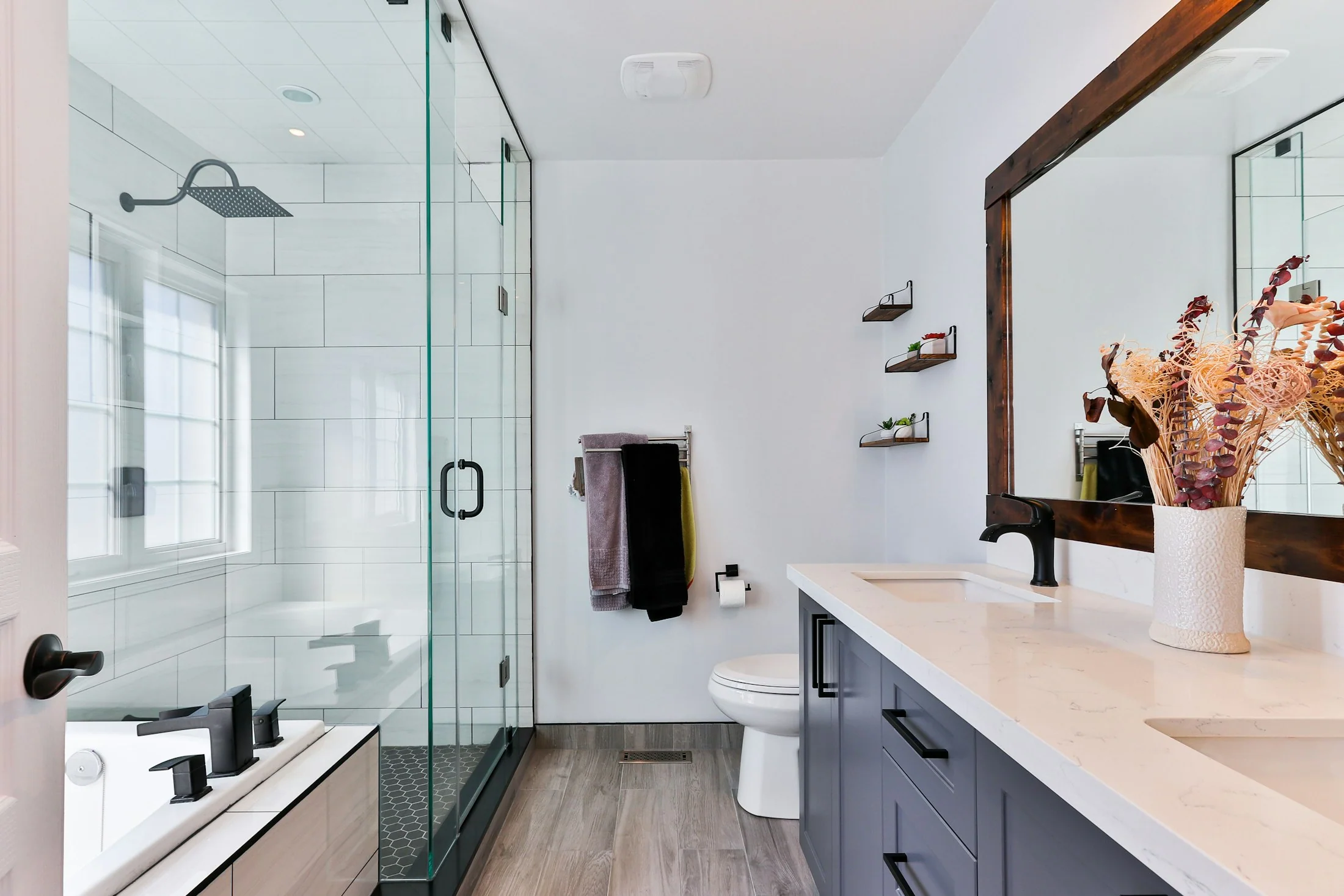 Bright bathroom with considered fittings, glass and stone surfaces